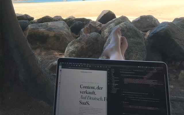 Laptop on the beach showing the Kamikarahcreates portfolio on screen