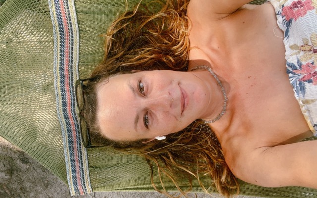 Sarah relaxing and smiling in a hammock